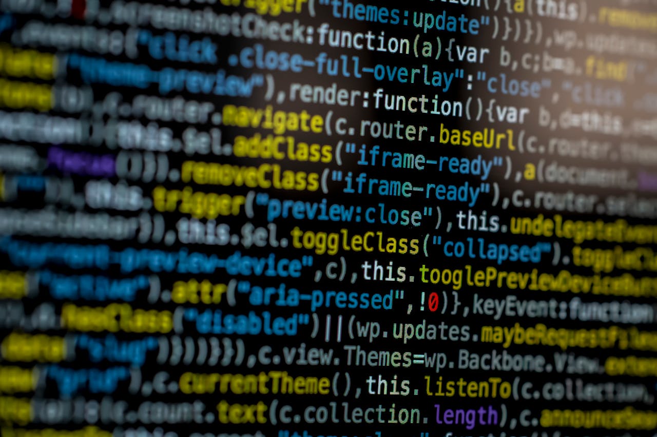 services-01 An extreme close-up of colorful programming code on a computer screen, showcasing development and software debugging.