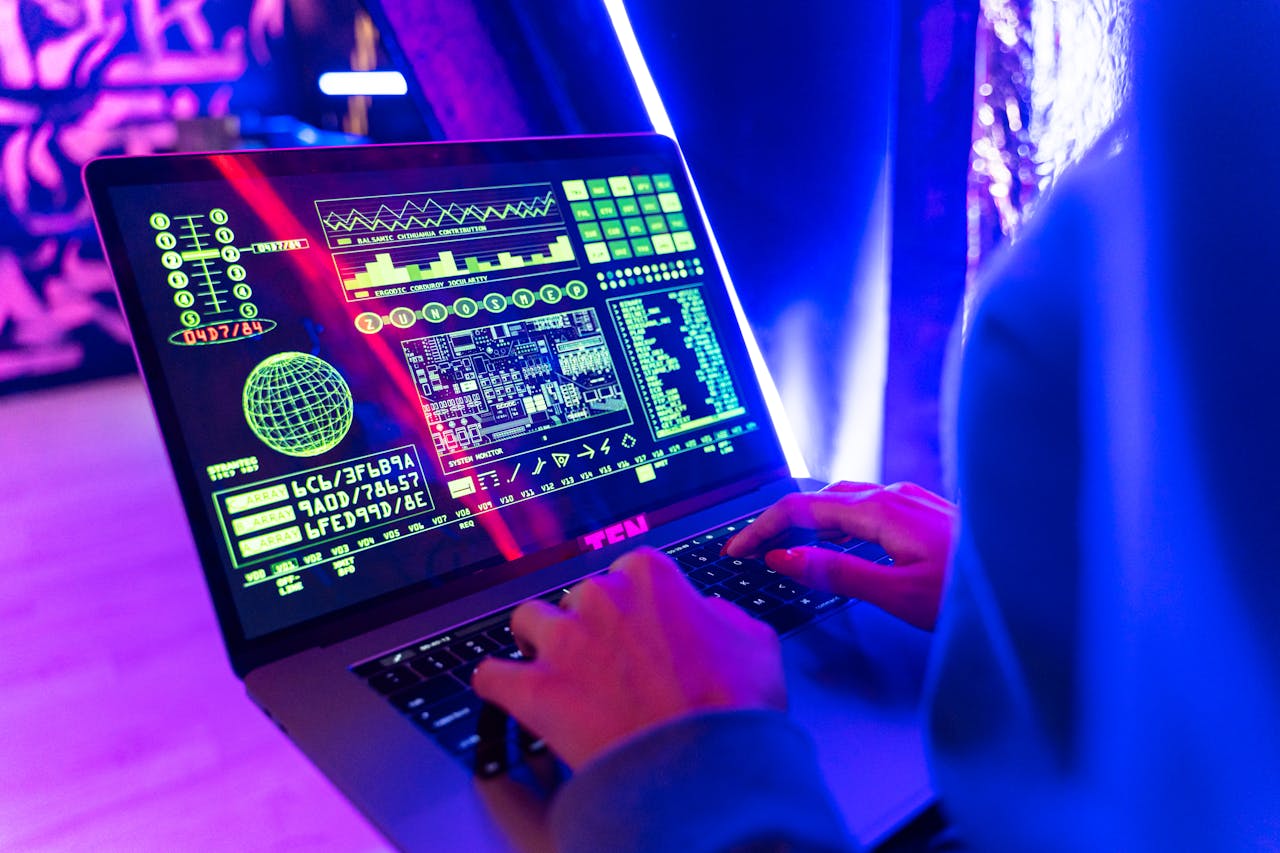 services-02 Person typing on a laptop with vibrant digital data display, highlighting cyber security.